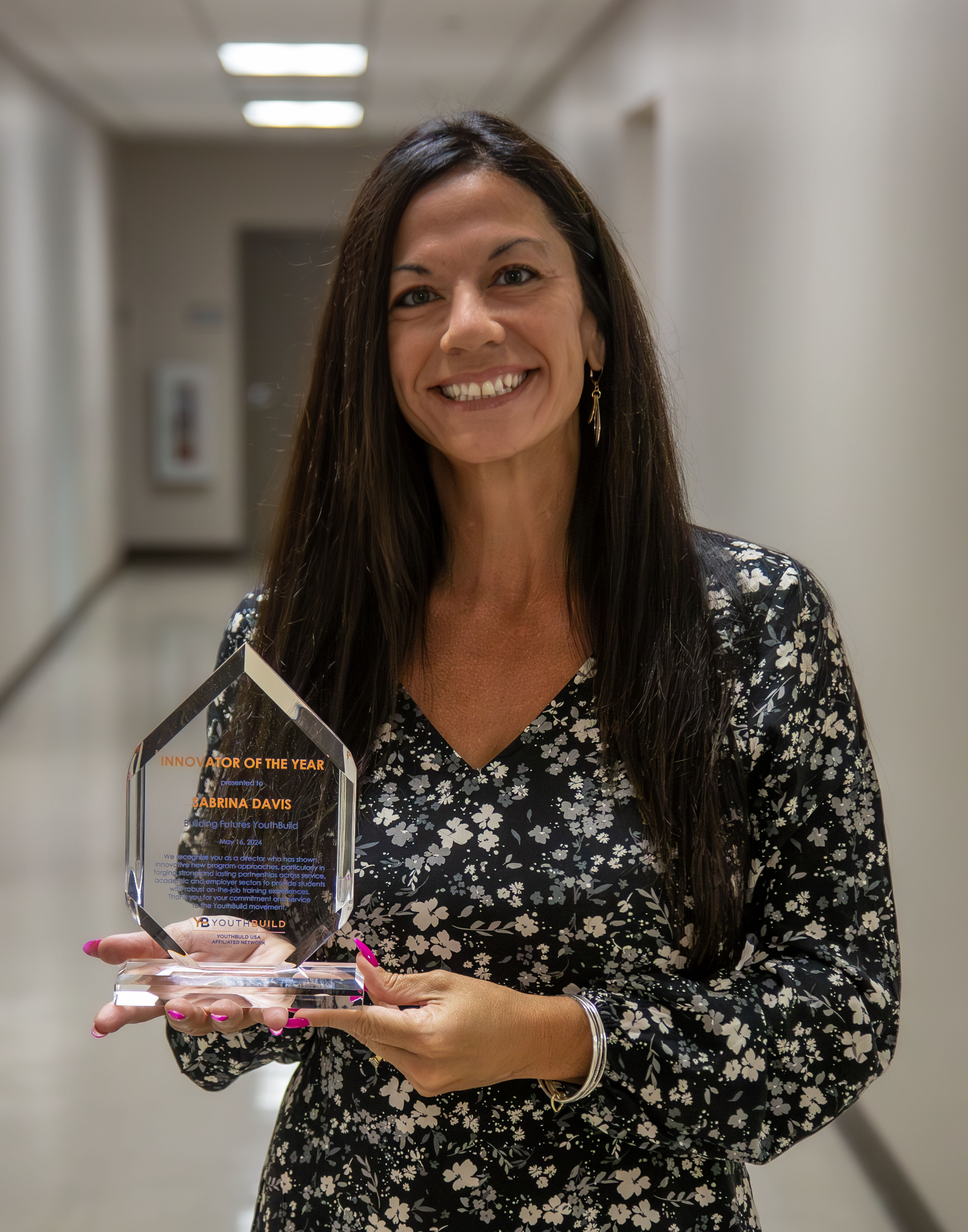 Sabrina Davis holding the YouthBuild USA Innovator of the Year award. Photo by Jan Dona, L&C Marketing/PR.