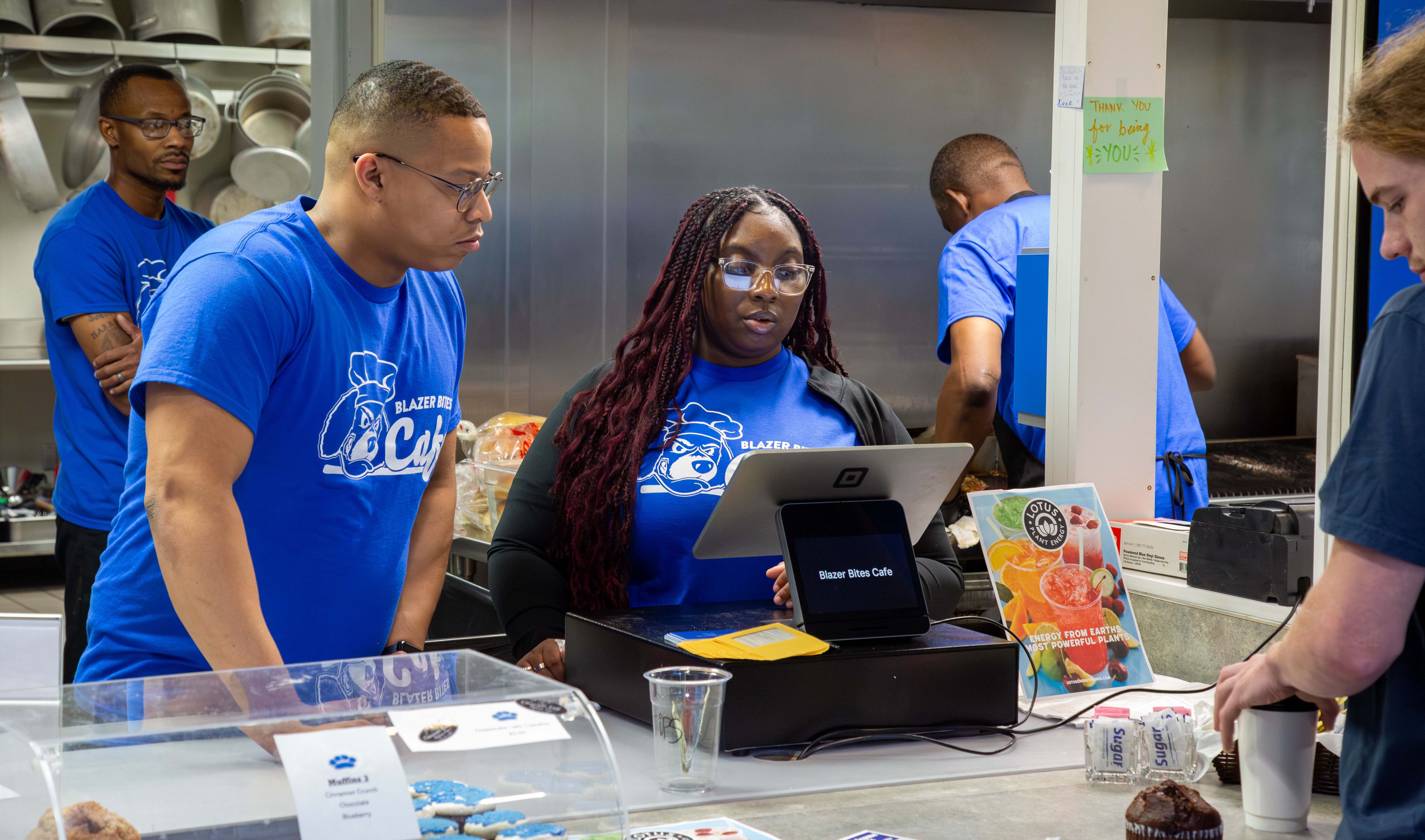 Pictured left to right, Jason Harrison (back left), Bradley Macon (front left) and Ashlynn Prather serve customers during opening week at the Blazer Bites Café. JARED SMILACK/L&C MARKETING & PR