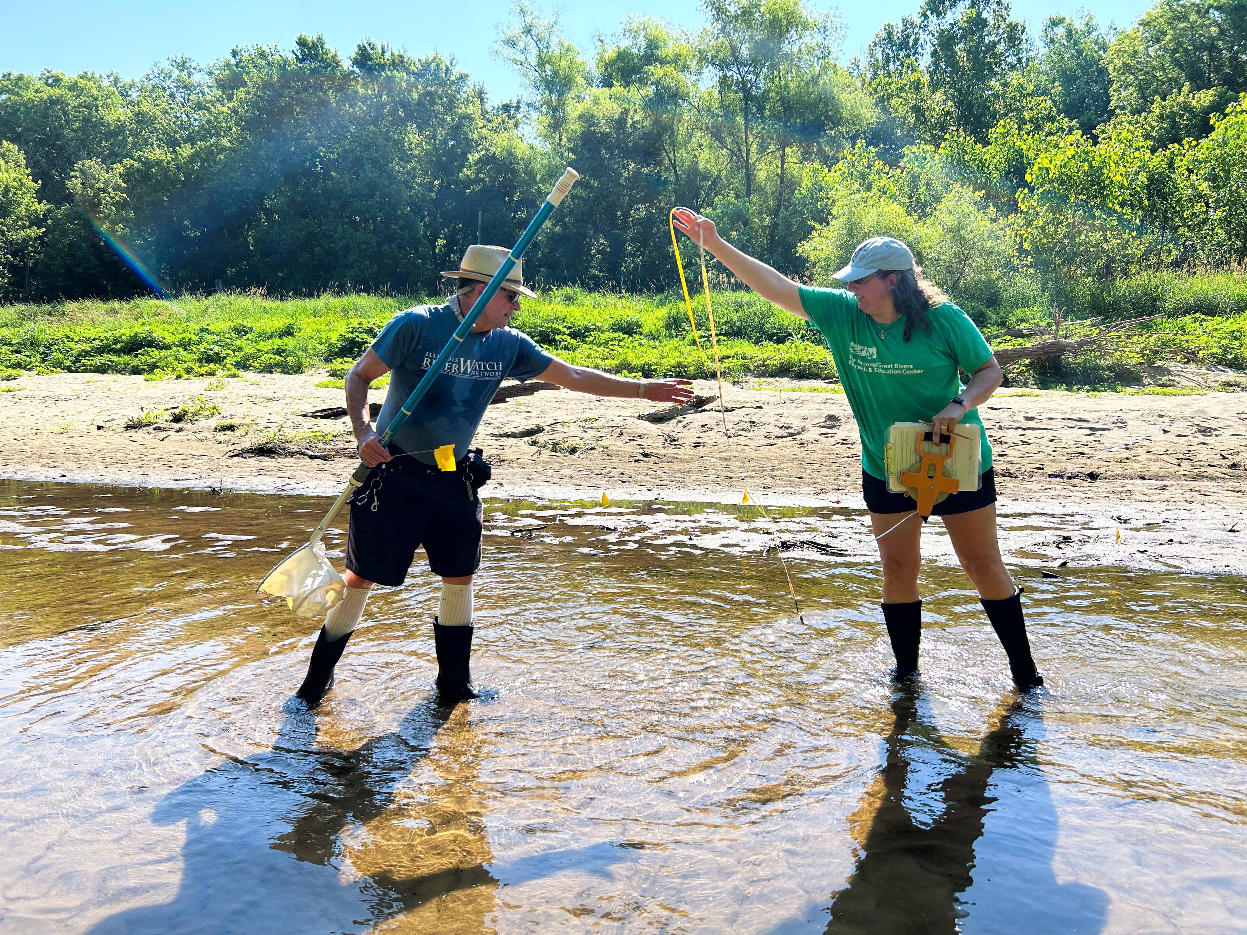 RiverWatch Director and Stream Ecologist Danelle Haake (right) and a volunteer community scientist work together to take a stream measurement during a macroinvertebrate study for the Illinois RiverWatch program. Photo provided by NGRREC