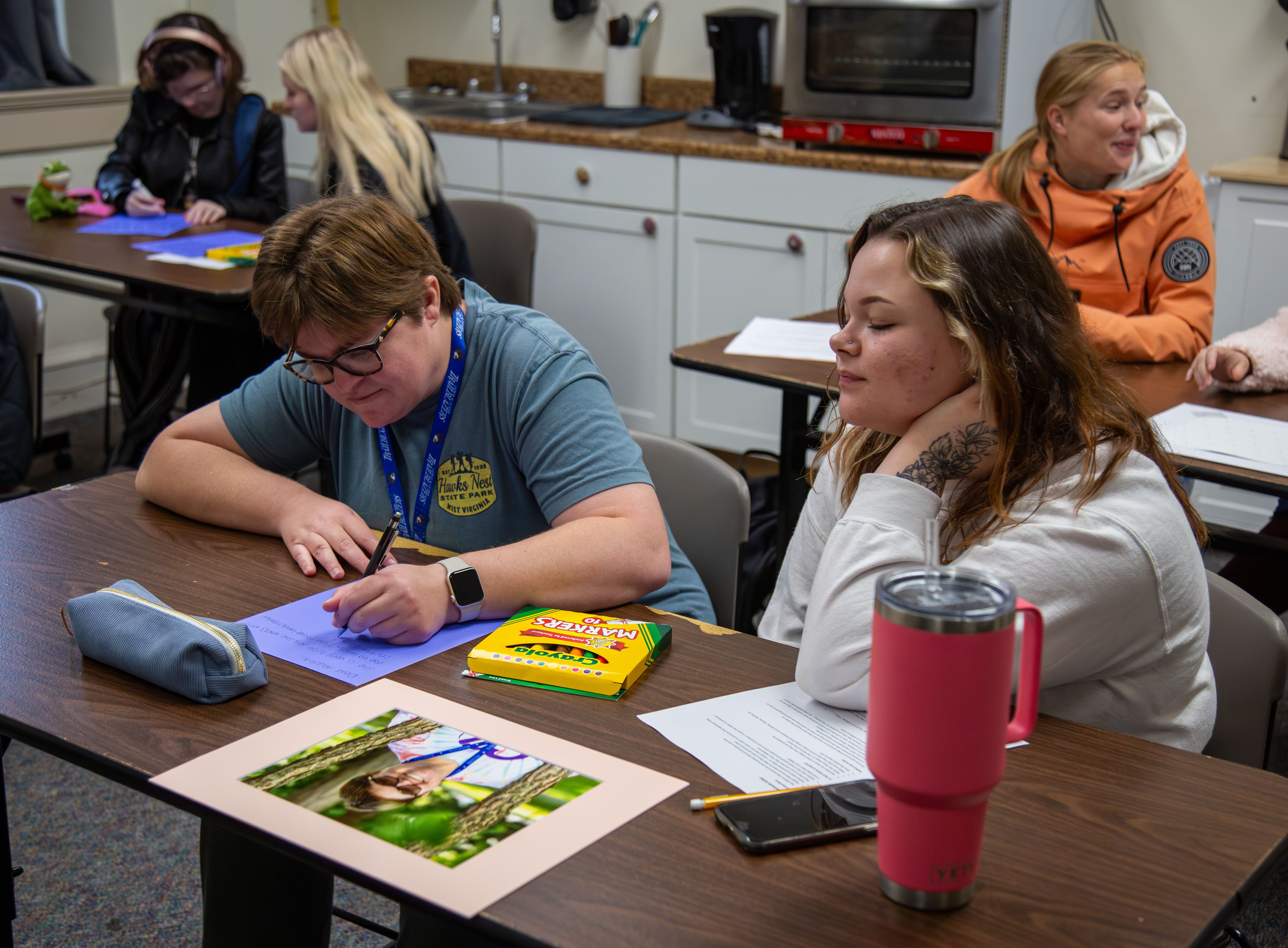 Lauren Williams (left) and Megan Ziegler (right) work on the Gratitude Letter Project together during the Science of Happiness class and College for Life collaboration.  JARED SMILACK/MARKETING & PR