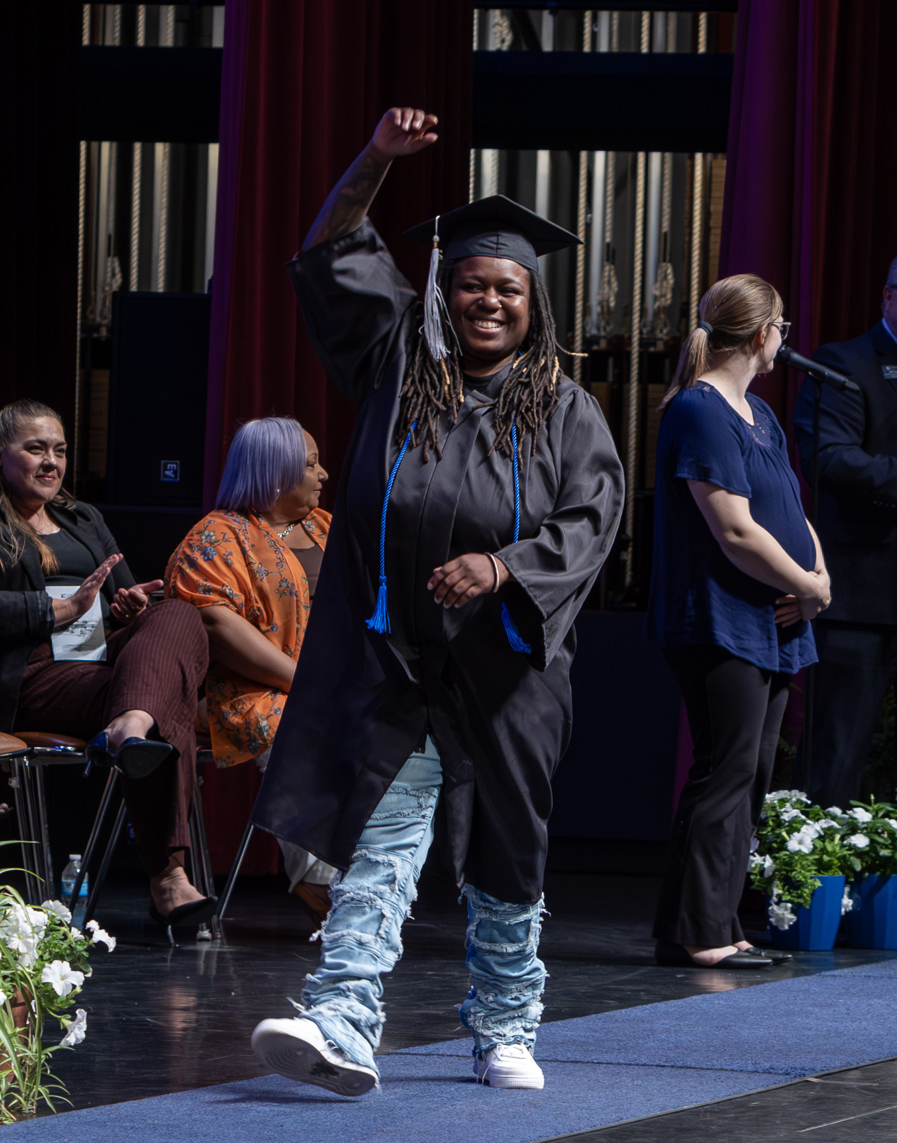 Pictured, graduate Brianna Stewart celebrates as she crosses the stage to receive her high school diploma.