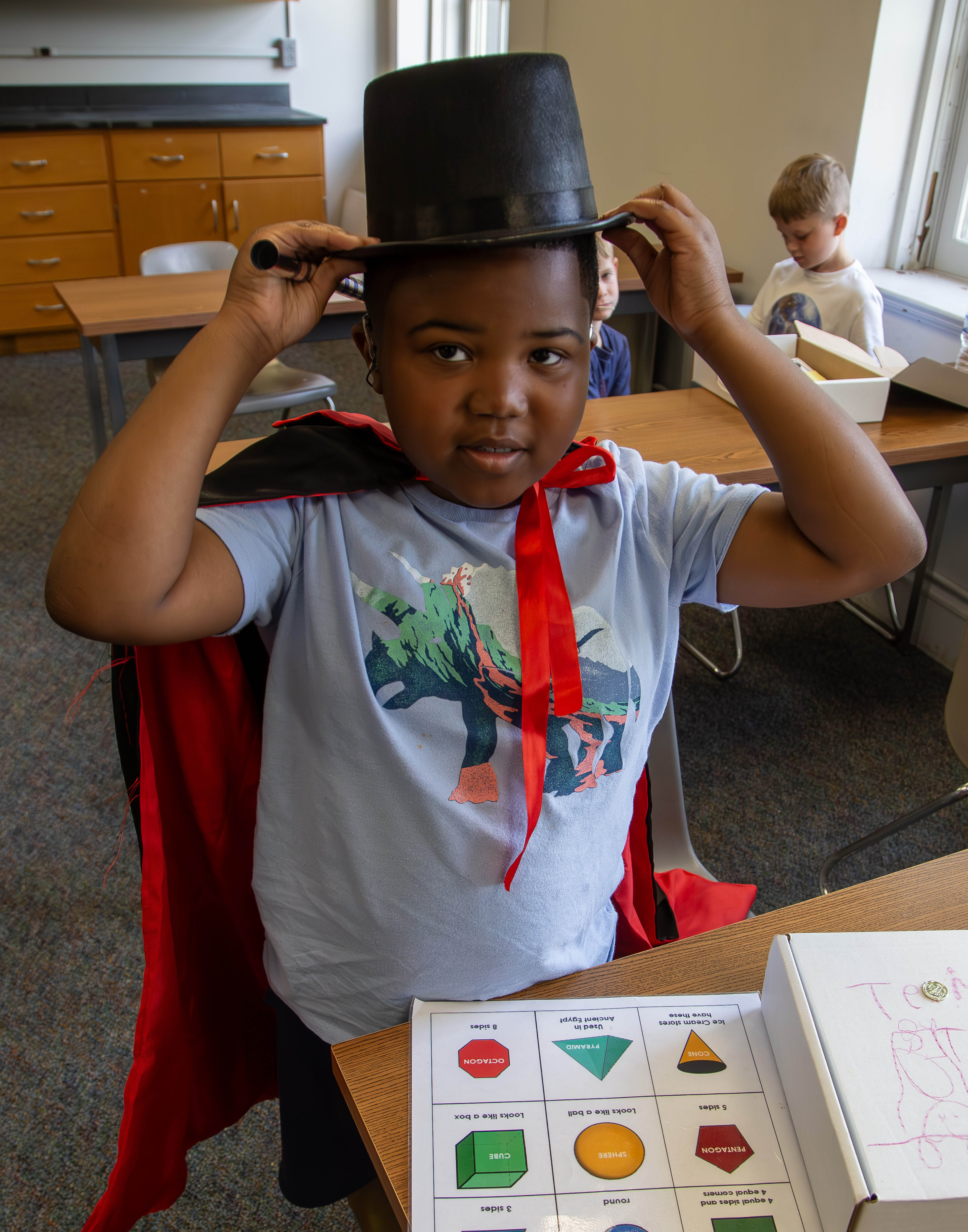 A College for Kids student learns about the wonders of magic tricks. LAURA INLOW/L&C MARKETING & PR