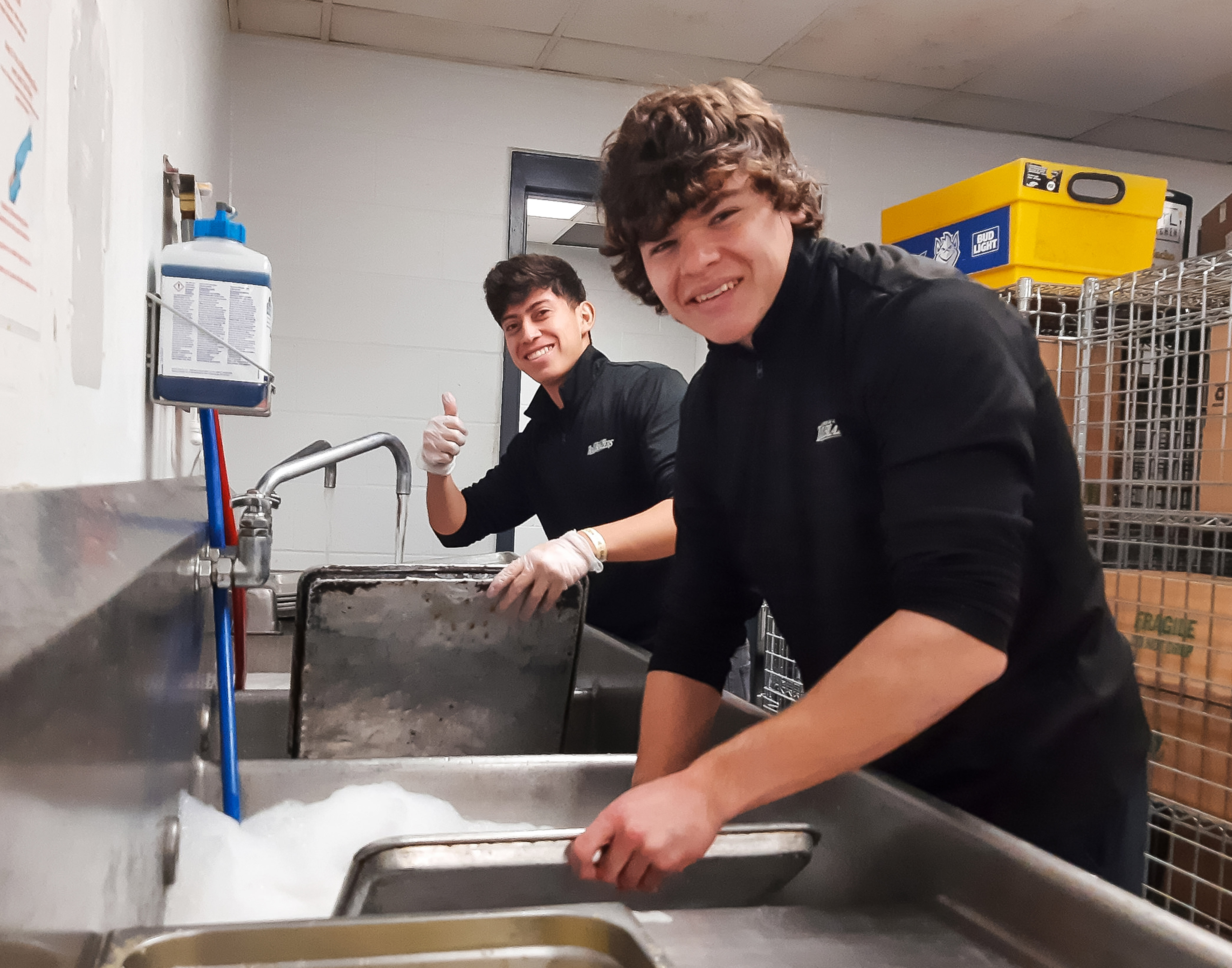 LC men’s soccer players Marco Carranza (left) and Will Meyer work clean-up duty at Enterprise Center during a Feb. 23 Blues game.