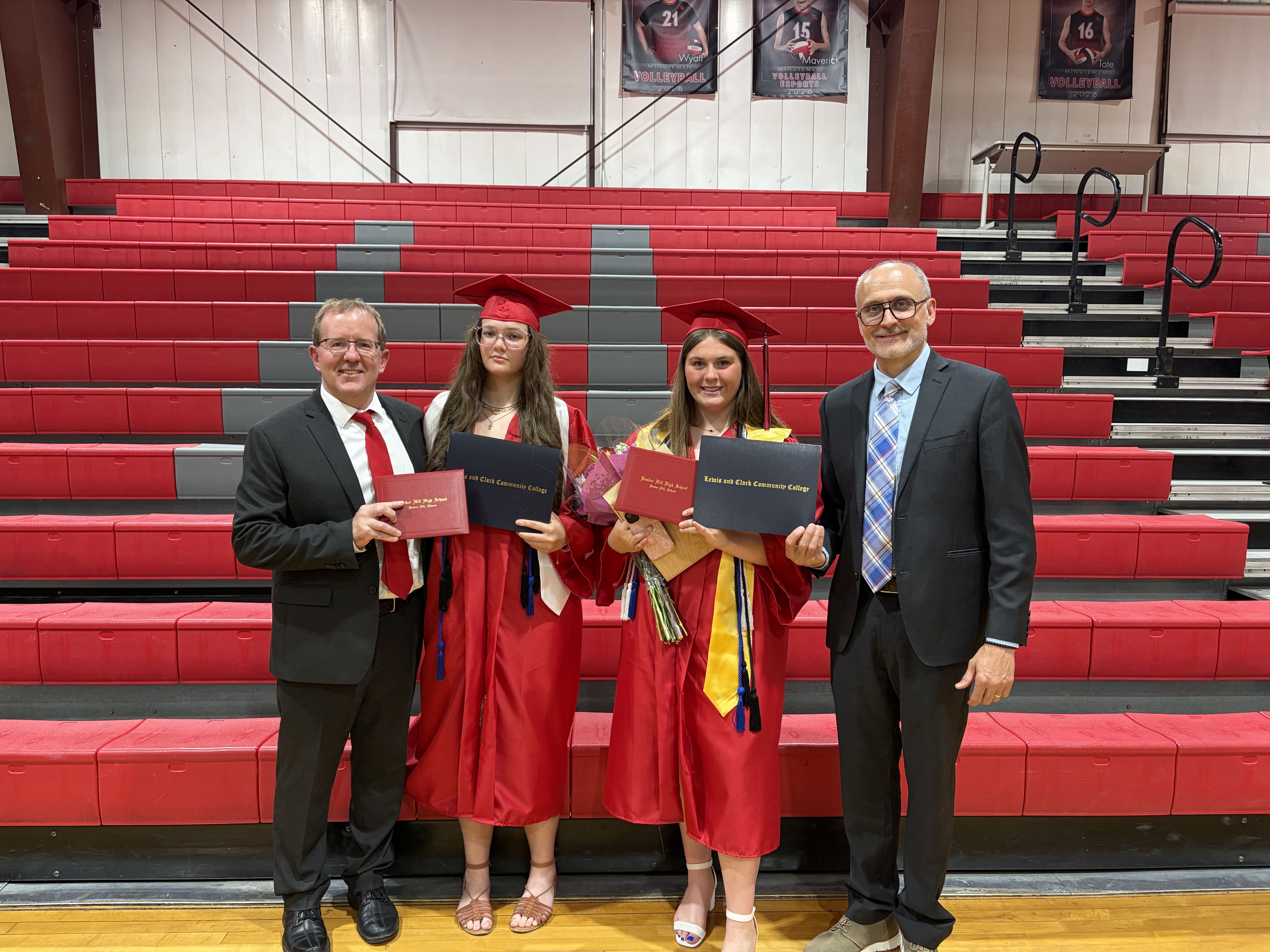 Pictured from left to right, Bunker Hill Superintendent Todd Dugan, Vivien Wilcox, Grace Burris, and Lewis and Clark Community College President Ken Trzaska. The group poses for a photo the night of Bunker Hill High School’s 2026 Graduation Ceremony.  