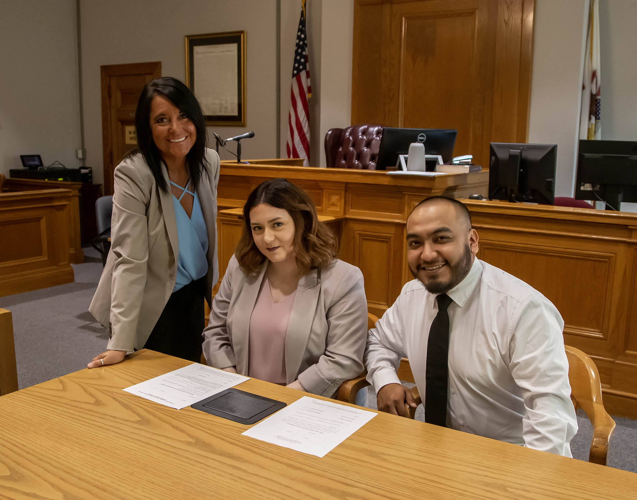 L&C Paralegal Program Coordinator Becky Gockel and students, Audrey Gorline and Gabriel Calixto, meet in a Madison County courtroom. Jan Dona, L&C Marketing & PR.