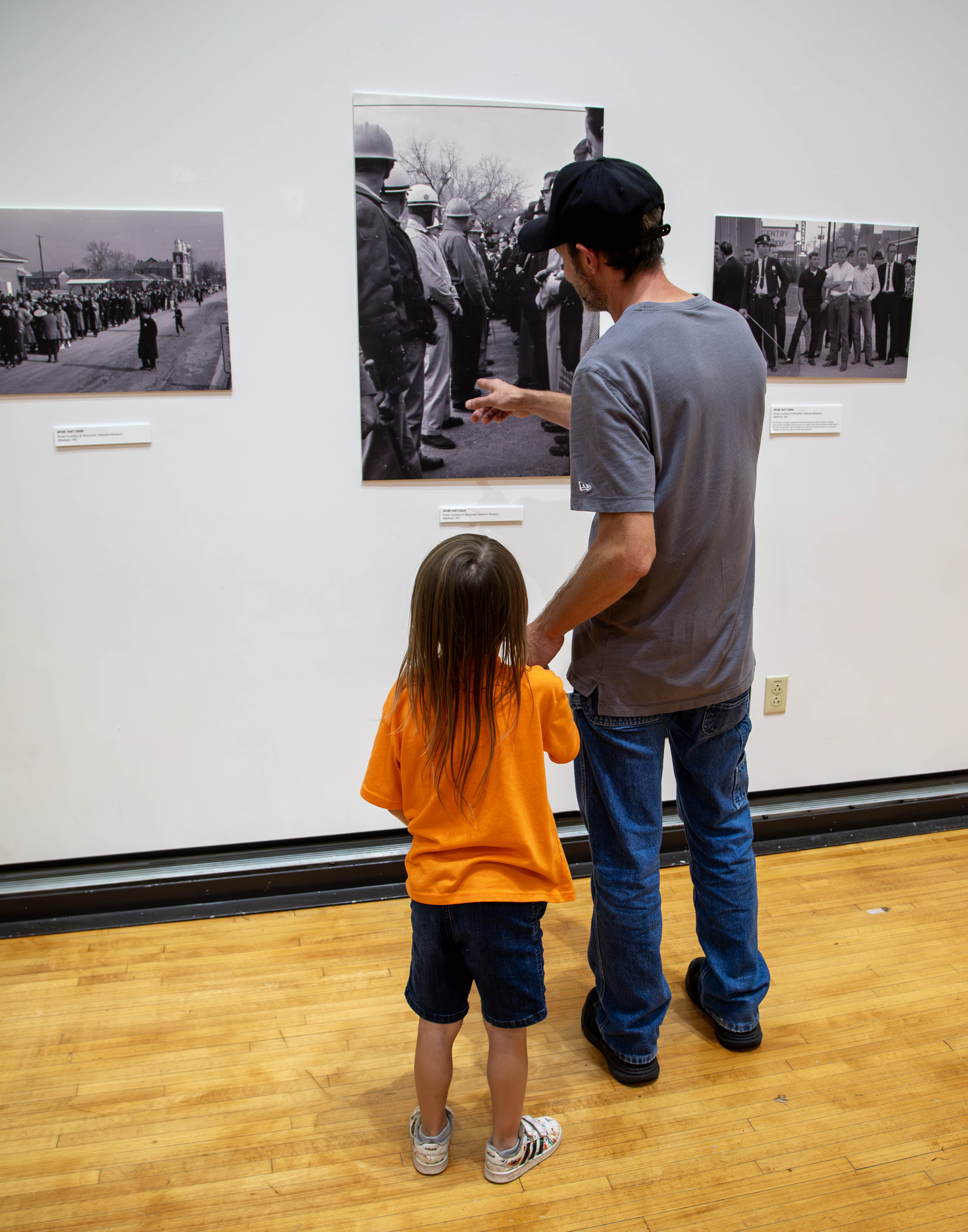 David Drew and his son, Xavier, both of Alton, take in the work of Robert J. Ellison in the Hatheway Gallery. The “Unfiltered Lens” exhibit is open through Aug. 31. JAN DONA/L&C MARKETING & PR