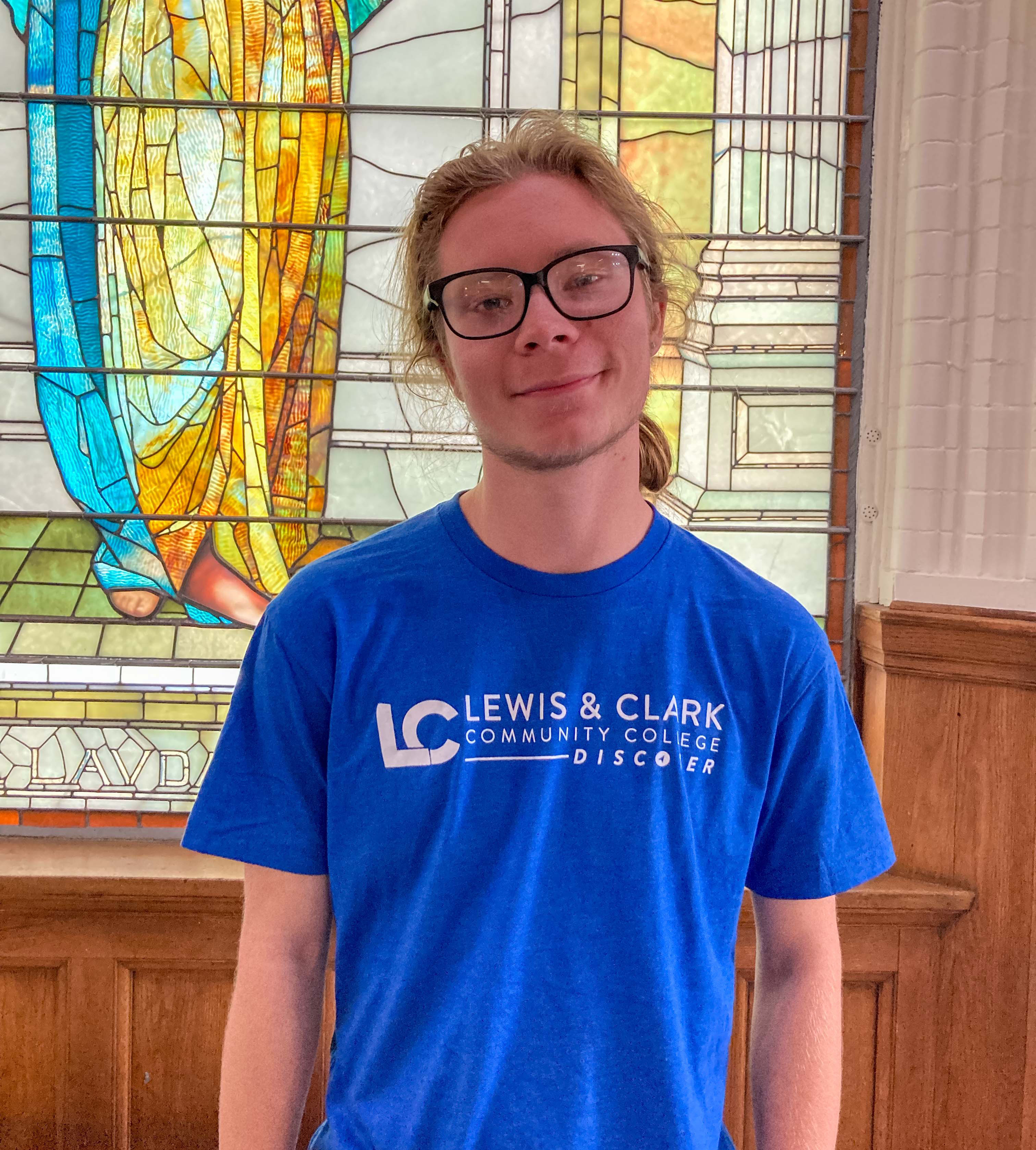 Andrew (Drew) Vincent pictured in front of the stained glass angel in Reid Memorial Library. JARED SMILACK/L&C MARKETING & PR