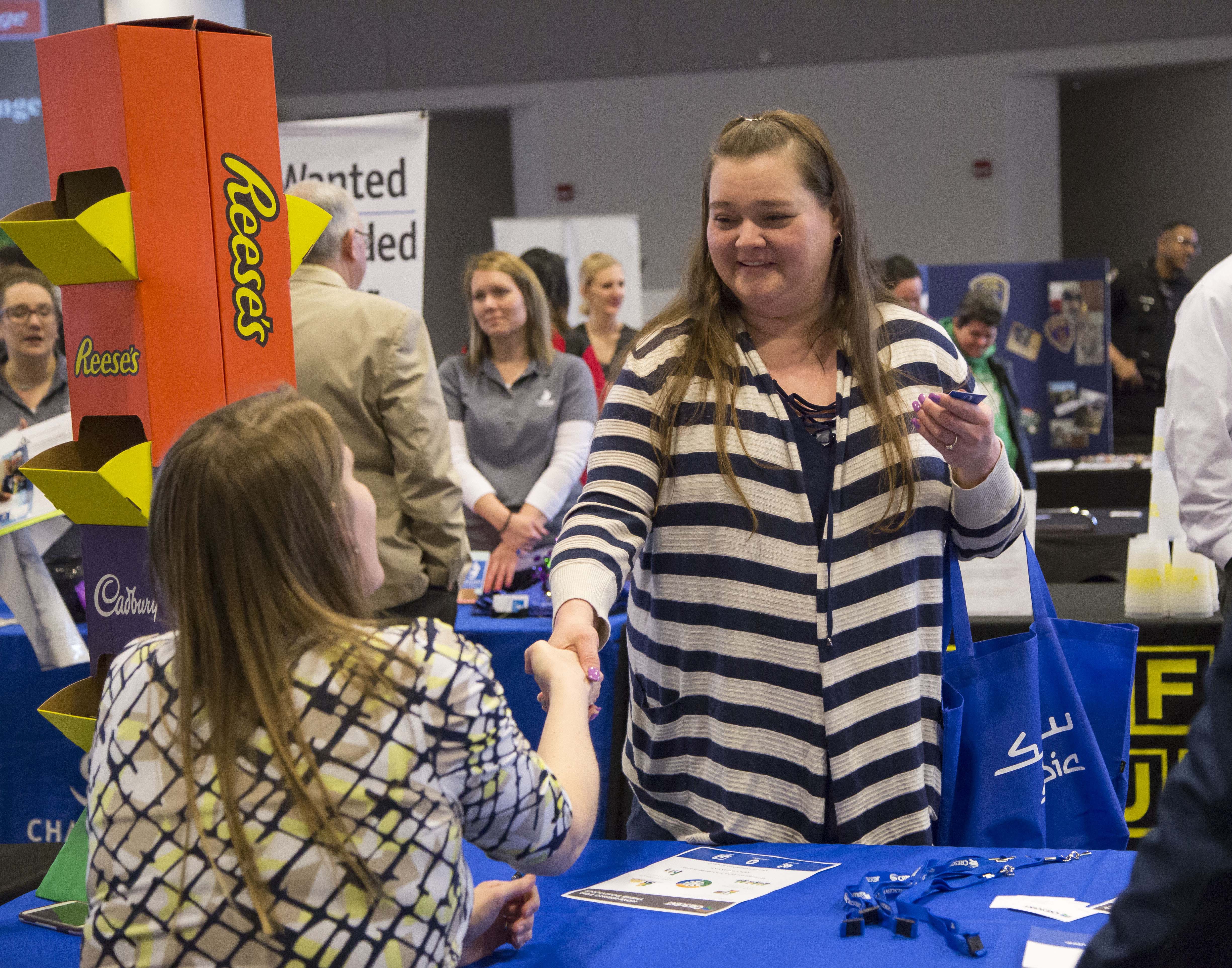 Job Fair attendees meet with potential employers. JAN DONA/L&C MARKETING & PR