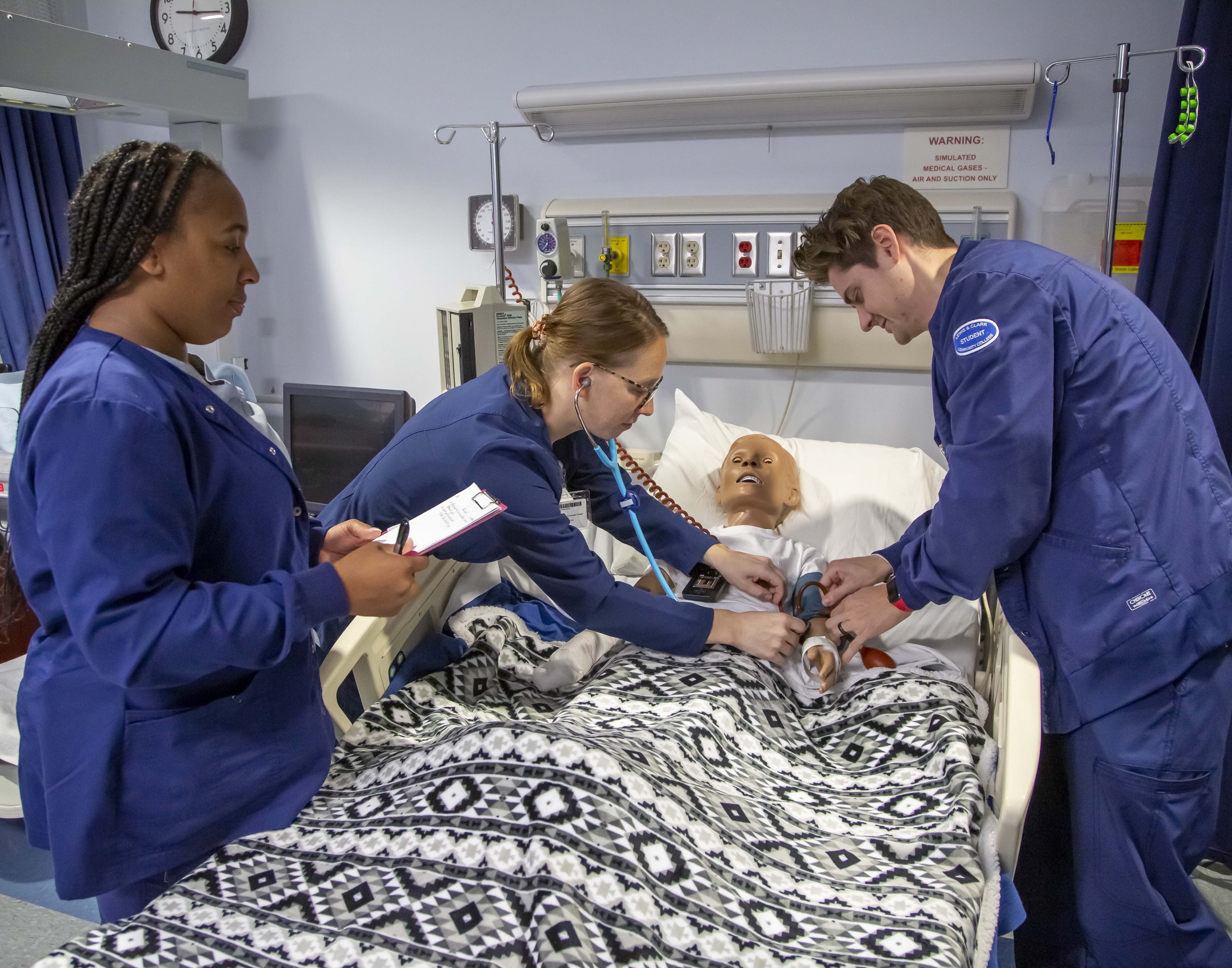 L&C Nursing students practicing on a simulator. Jan Dona, L&C Marketing/PR.