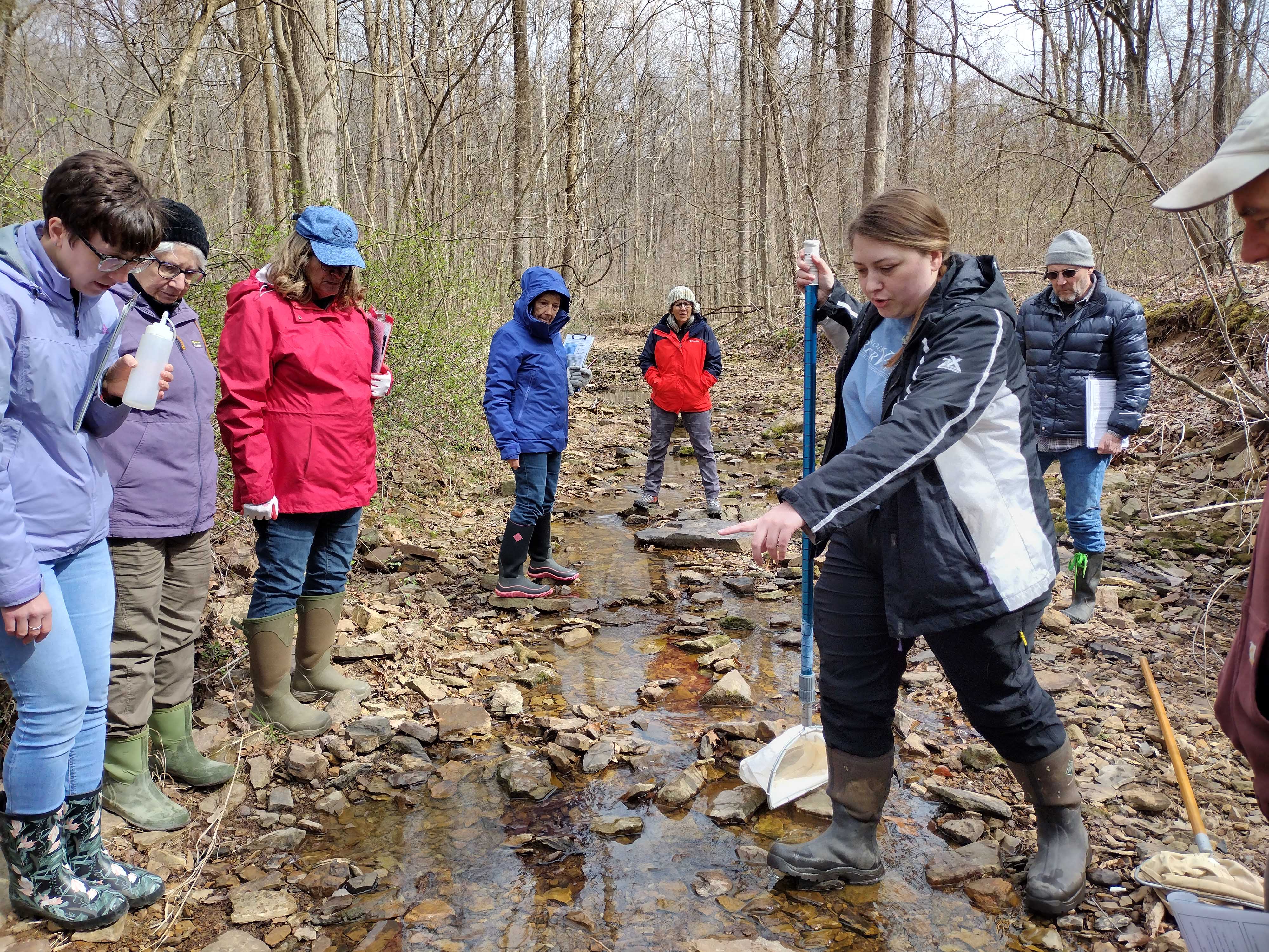 Hannah Griffis teaches RiverWatch volunteers how to collect stream quality data. Photo by Anne Townsend.
