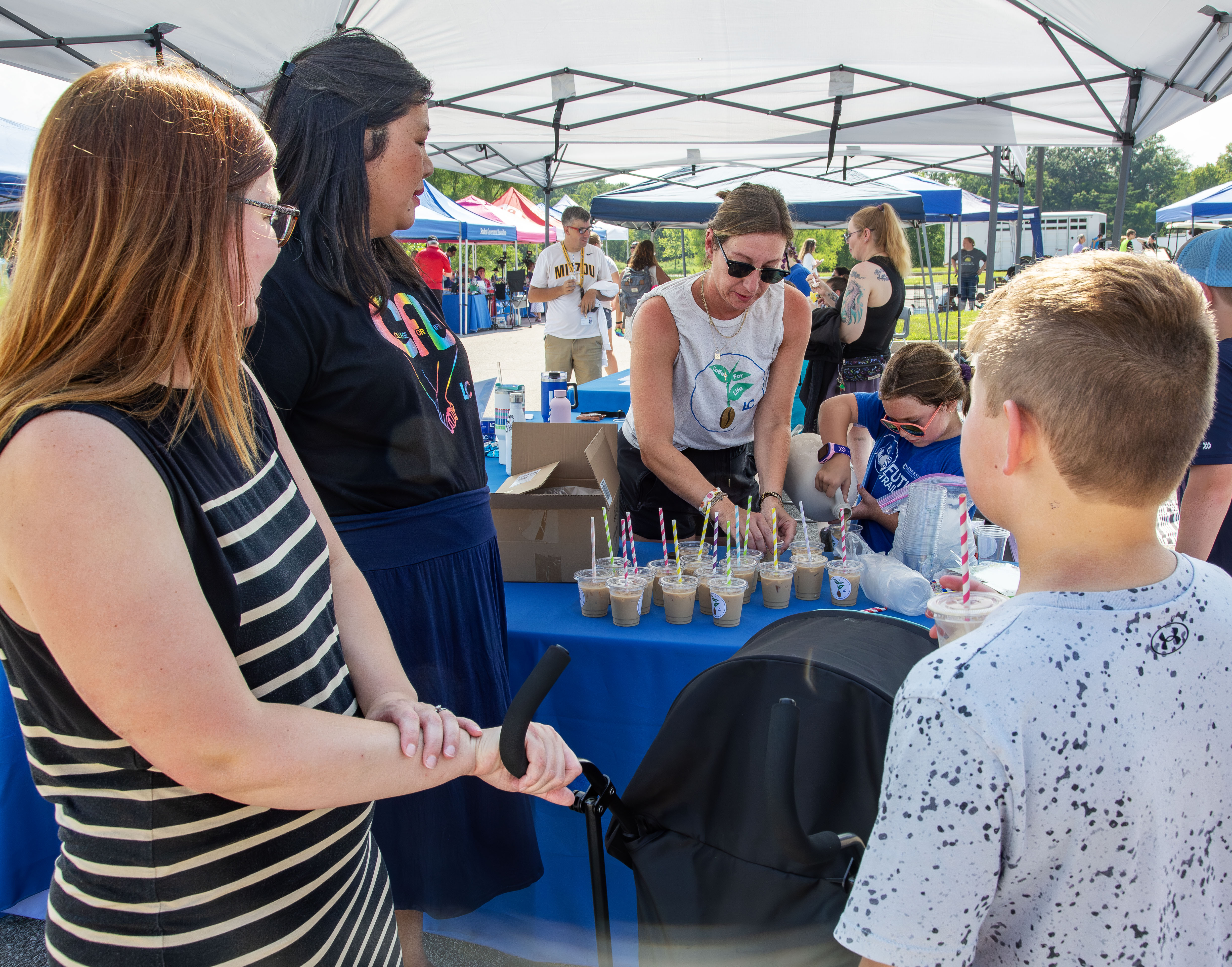 Katelyn Baahlmann and Rosie Ellington of L&C’s College for Life program hand out free iced coffees from Bunkhouse Joe.