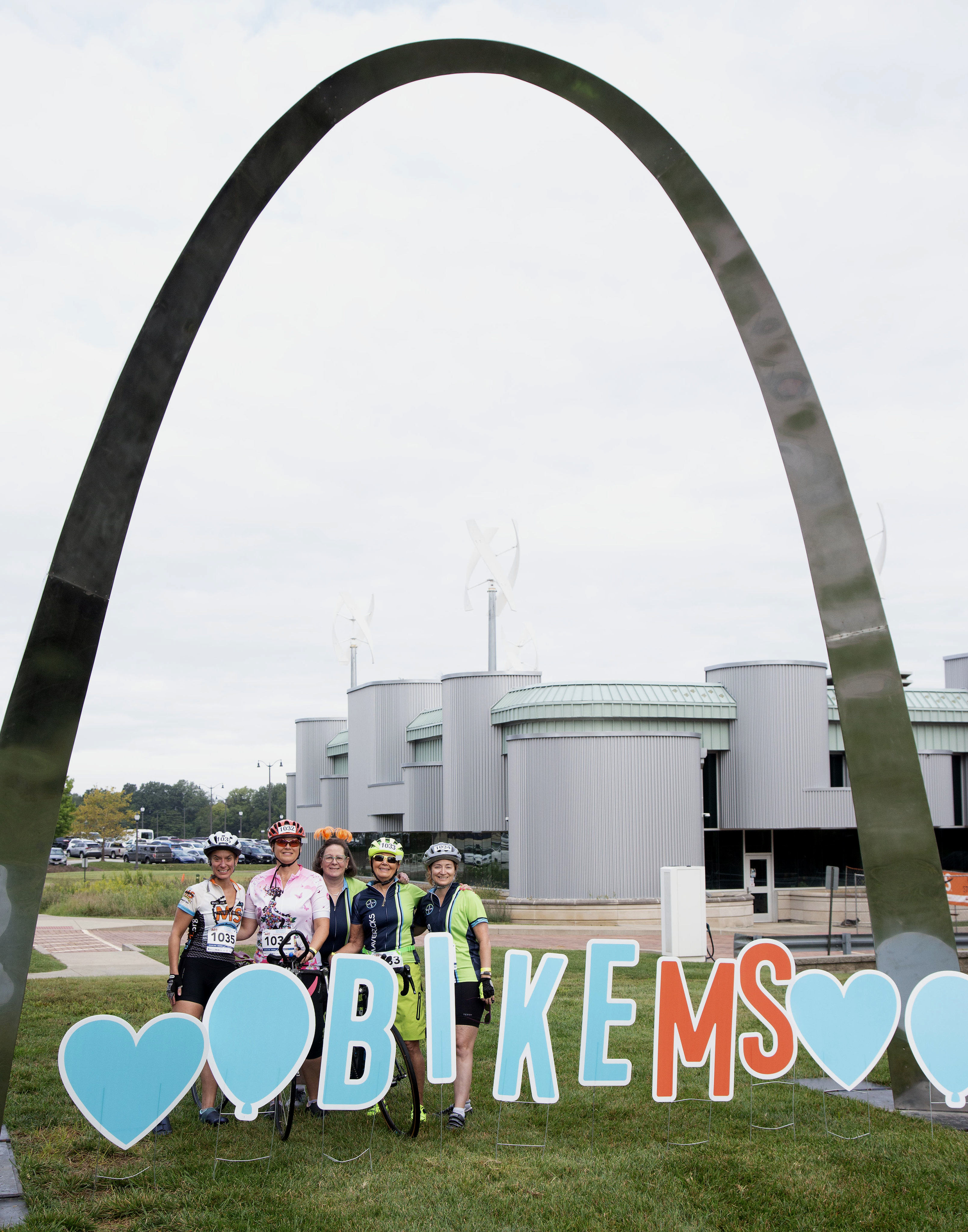 riders at the 2023 Bike MS: Gateway Getaway Ride pose for a photo with a sculpture of the St. Louis Arch, located in front of the Weber Workforce Center on the college’s Godfrey Campus. Photos by Laura Inlow, L&C Marketing & PR