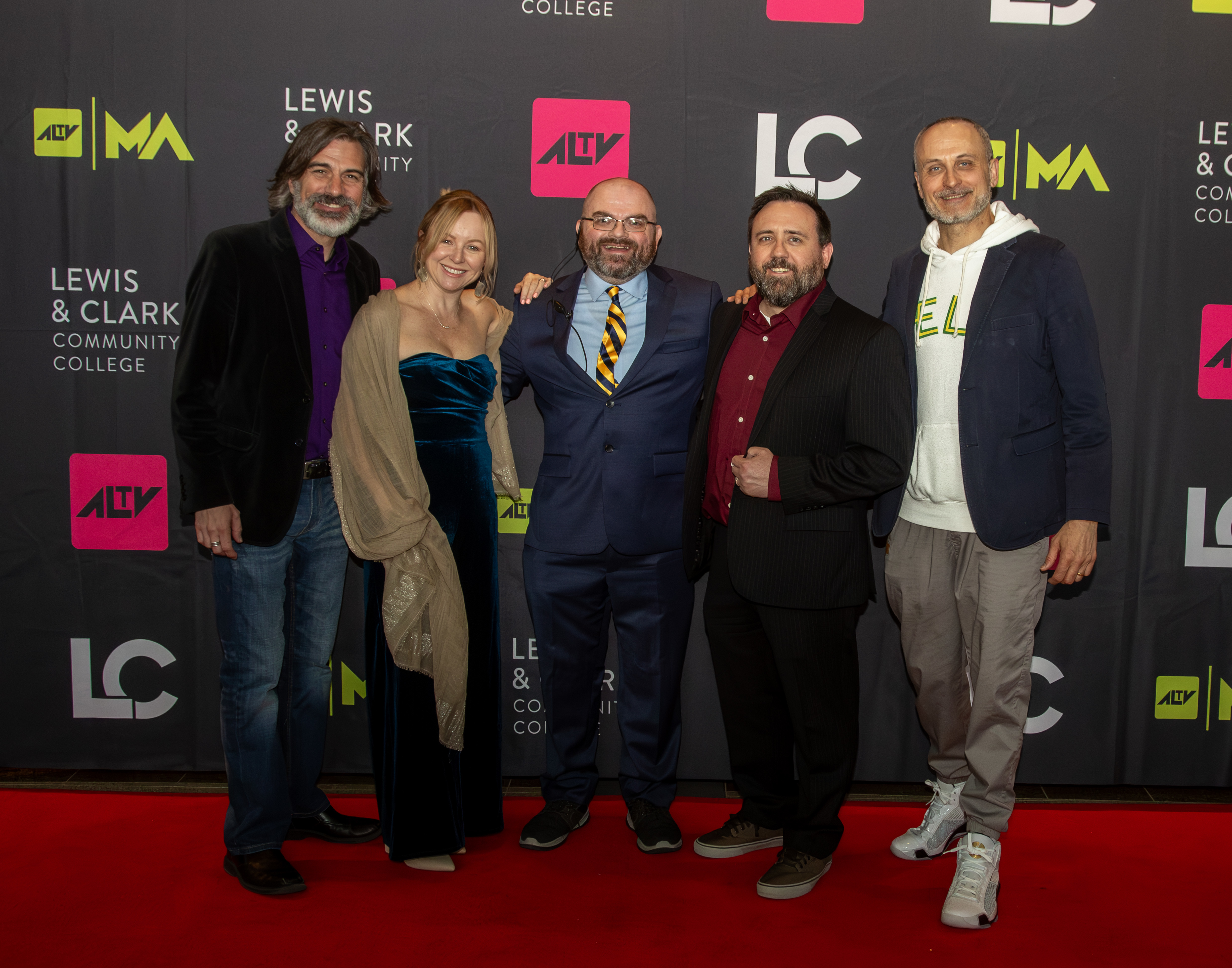 Pictured from left, L&C Professor of Music Peter Hussey, Associate Professor of Sociology Jen Cline, Always Late TV Festival Director Kevin Edwards, Professor of English Steve Higgins and L&C President Ken Trzaska pose for a photo on the red carpet during the 2024 event. JAN DONA/L&C Marketing & PR