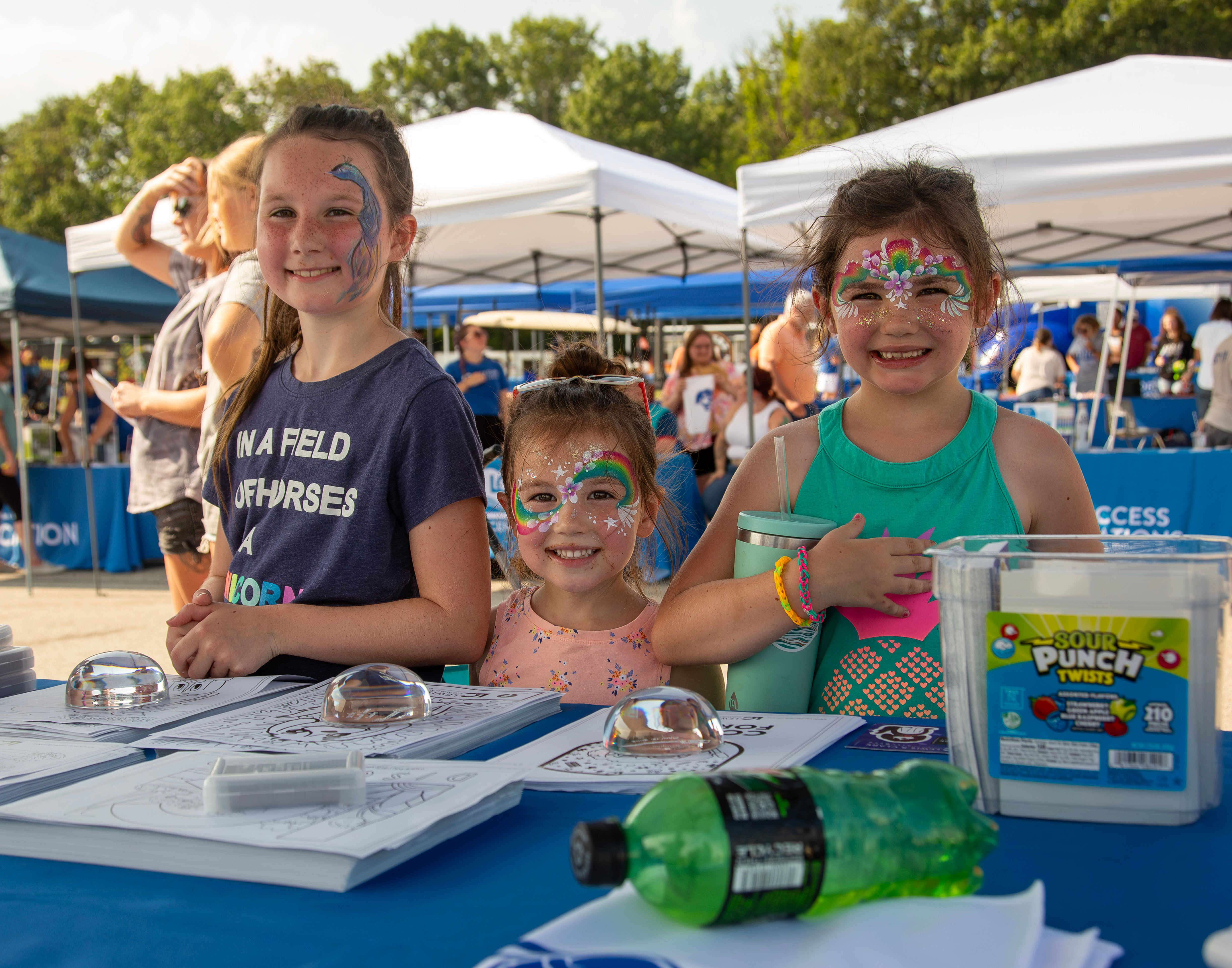 Smiling Summerfest attendees decked out in face paint. JAN DONA/MARKETING & PR