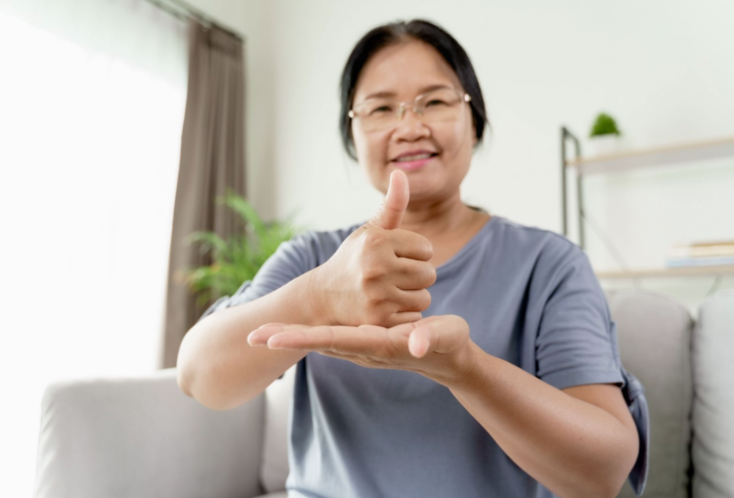 Woman uses American Sign Language to communicate. Stock photo from Vecteezy.com