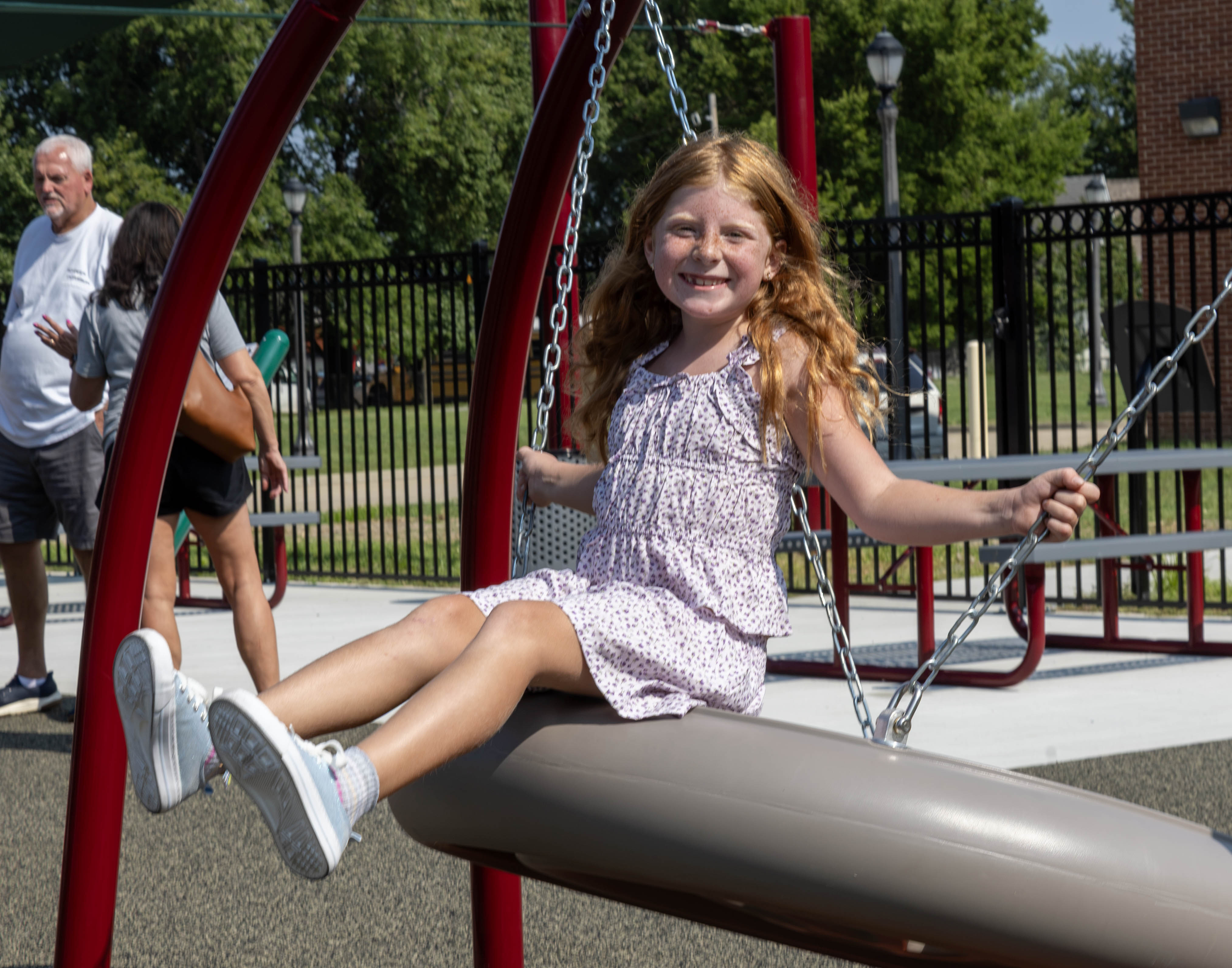 Blaire Wilson takes a ride on the saucer swing.