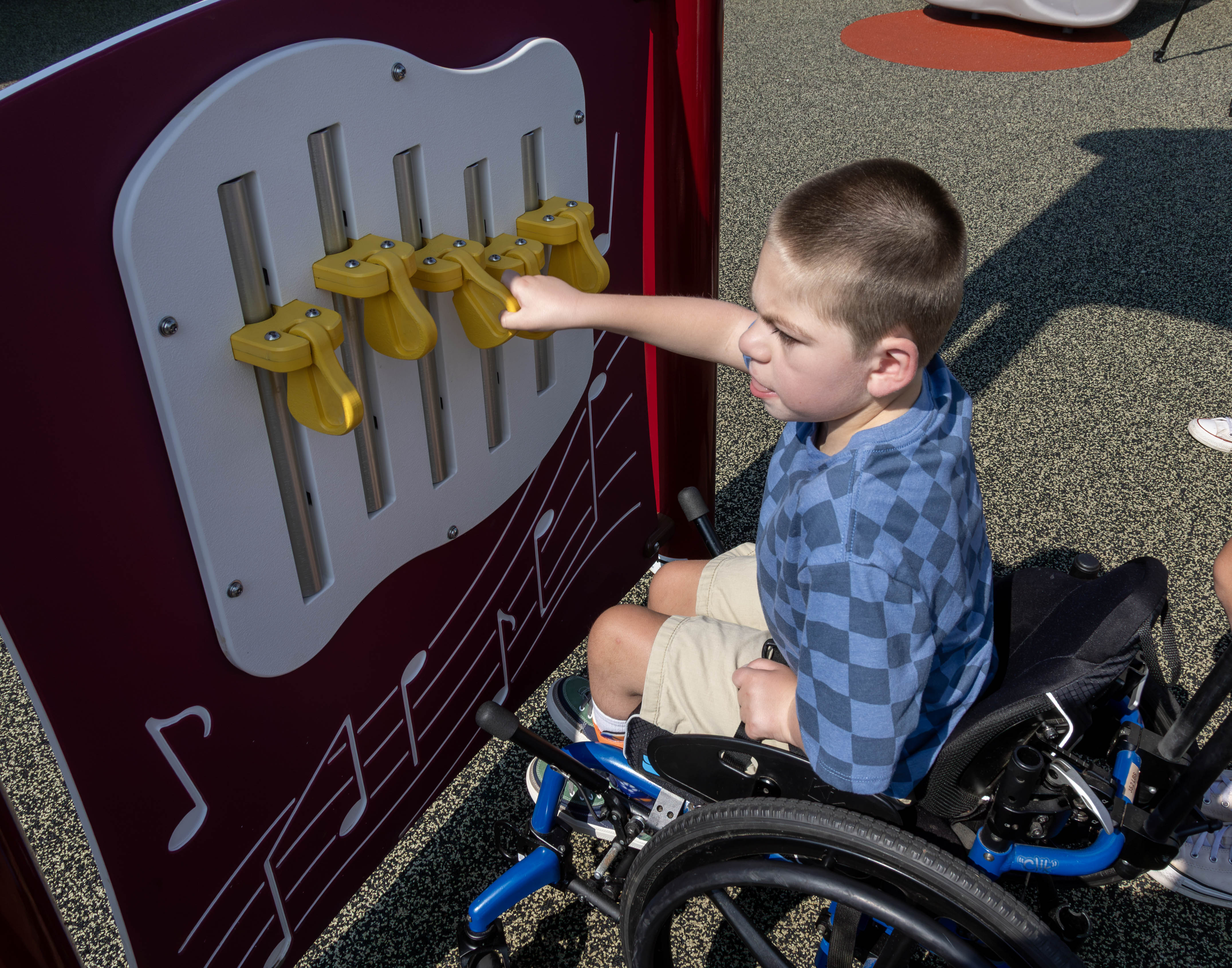 Henry Dunn makes music with the interactive chime panel.