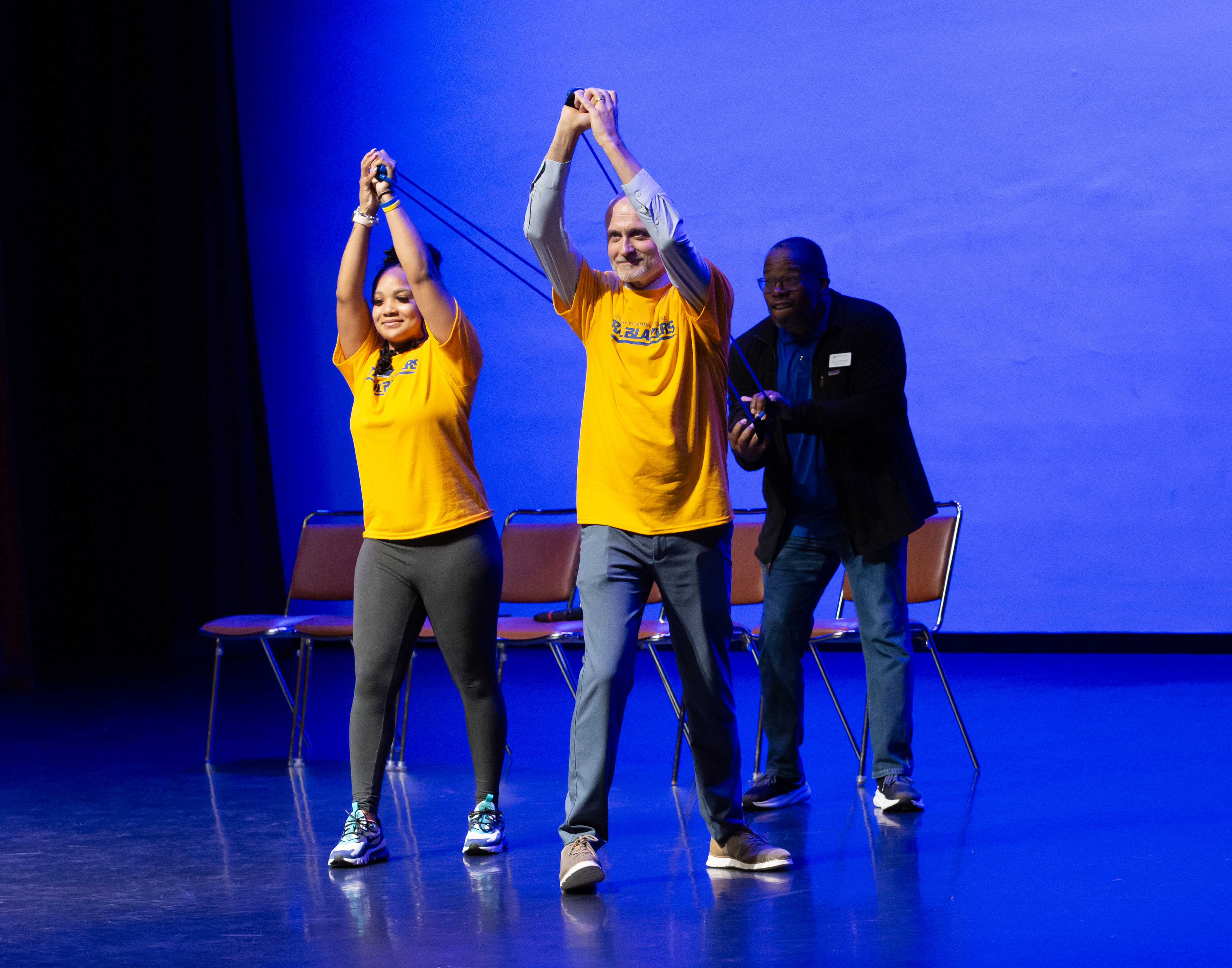Student Activities Coordinator Jayla Fox, Dean of Students Sean Hill (back) and LC President Ken Trzaska launch T-shirts into the crowd from the stage inside the Hatheway Cultural Center’s Ann Whitney Olin Theatre during Trailblazer Welcome Day. 